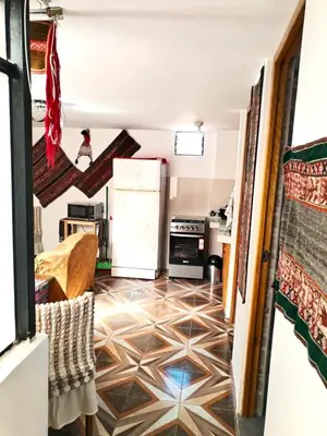a kitchen with a tile floor and a refrigerator at Encanto del Cusco in Cusco