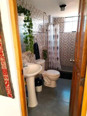a bathroom with a sink and a toilet and a shower at Encanto del Cusco in Cusco