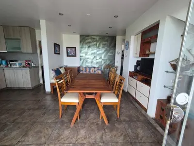 a kitchen with a wooden table and chairs in a room at Front Beach House nearby Playa Asia in Lima, Peru! in Cerro Azul