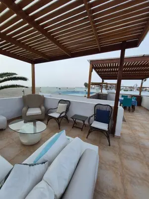 a living room with a couch and chairs and a table at Front Beach House nearby Playa Asia in Lima, Peru! in Cerro Azul