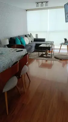 a living room with a bed and a couch at Habitación in Lima
