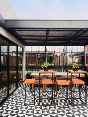 a restaurant with tables and chairs on a checkered floor at M15 - Two Bedroom Apartment in front of the US Embassy in Lima