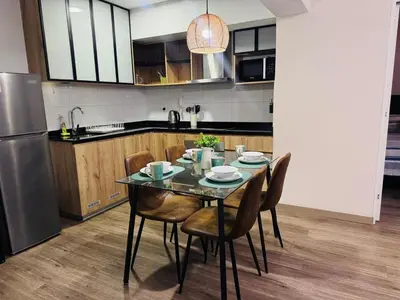 a kitchen with a table with chairs and a refrigerator at M24 Departamento de 2 Dorm 2 baños - Frente Embajada de USA in Lima