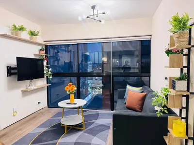 a living room with a couch and a table at M24 Departamento de 2 Dorm 2 baños - Frente Embajada de USA in Lima
