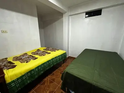 a bedroom with two beds in a room at Quinta Maravillas in Ayacucho