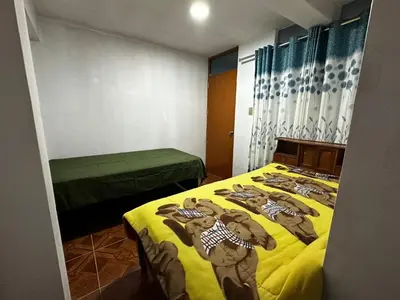 a room with two beds in a room at Quinta Maravillas in Ayacucho