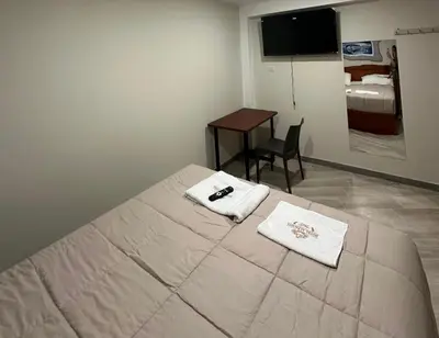 a bedroom with a bed with two towels on it at Hotel Altavista in Abancay