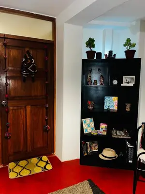 a room with a door and a shelf with pictures at AndeanNook-Cusco in Cusco