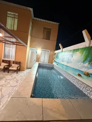 a swimming pool in front of a house at night at Sweet Rustic Home in Salinas