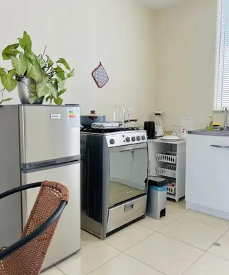 a kitchen with a stove and a refrigerator at Encantadora casa en Menorca - Ica in Ica