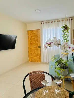 a room with a table and a chair and a television at Encantadora casa en Menorca - Ica in Ica