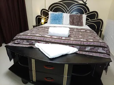 a bedroom with a large bed with a black headboard at Machupicchu Royal Mountain in Machu Picchu