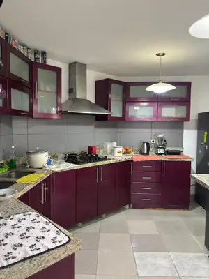a kitchen with purple cabinets and a stove top oven at Casa Portada del Sol La Molina in Lima