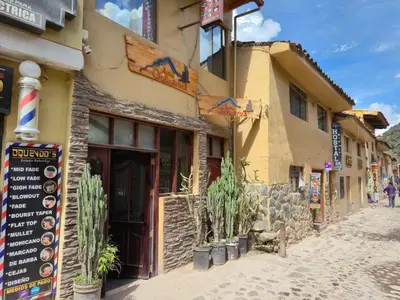 a street in a town with a building at Qhawarina Hostel Ollantaytambo in Ollantaytambo
