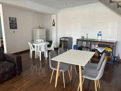 a living room with a white table and chairs at Casa playa in Barranca