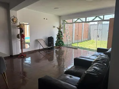 a living room with a christmas tree and a couch at Casa playa in Barranca