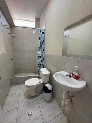 a bathroom with a toilet and a sink at Casa playa in Barranca