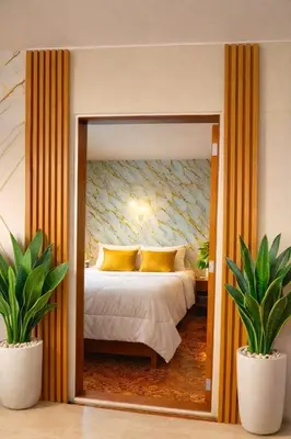 a bedroom with a bed and two potted plants at Modern y Cozy Apartment Prime Location Fast WiFi in Lima