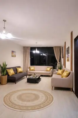 a living room with two couches and a rug at Modern y Cozy Apartment Prime Location Fast WiFi in Lima