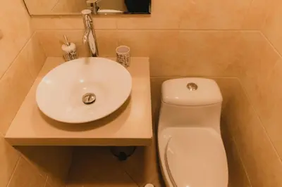 a white sink and a toilet in a bathroom at Recavarren 3 Dormitorios by Casa Miraflores - Wifi - Washer - Hot Water in Lima