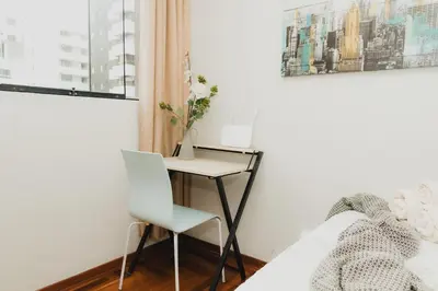 a bedroom with a desk and a bed with a chair at Galvez 3 Dormitorios by Casa Miraflores - Wifi Washer Hot Water in Lima
