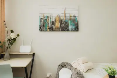 a bedroom with a city painting on the wall at Galvez 3 Dormitorios by Casa Miraflores - Wifi Washer Hot Water in Lima