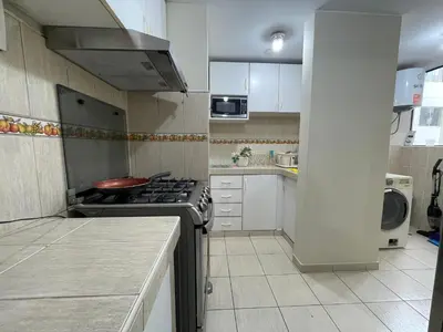 a kitchen with a stove and a sink in it at Galvez 3 Dormitorios by Casa Miraflores - Wifi Washer Hot Water in Lima