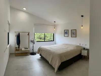 a bedroom with a large bed and a window at Casa de Campo Azpitia Perú in Santa Cruz de Flores