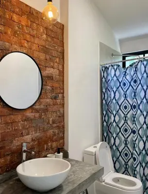 a bathroom with a sink and a mirror and a toilet at Casa de Campo Azpitia Perú in Santa Cruz de Flores