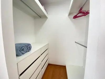 a room with white walls and white cabinets and blue towels at Mendiburu 2 Dormitorios by Casa Miraflores - Wifi - Hot Water in Lima