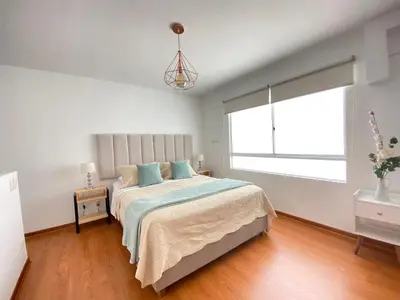 a white bedroom with a large bed and a window at Mendiburu 2 Dormitorios by Casa Miraflores - Wifi - Hot Water in Lima