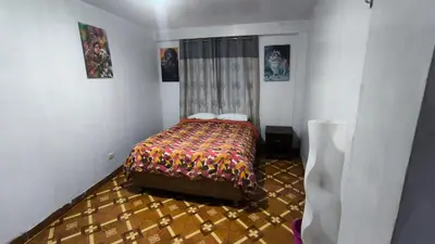 a small bedroom with a bed in a room at Victoria home san blas in Cusco