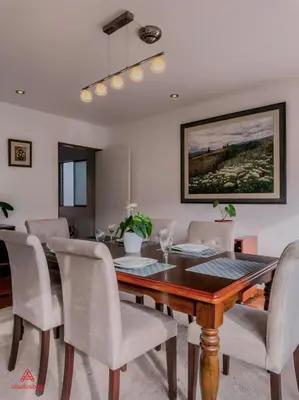 a dining room with a wooden table and chairs at Cozy Retreat in the Heart of Surco in Lima