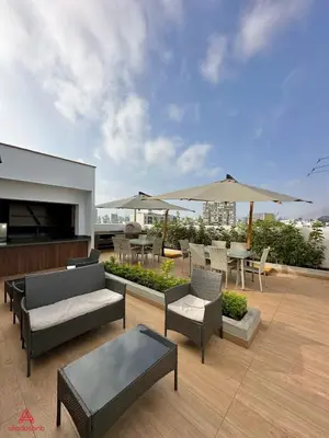 a patio with tables and chairs and umbrellas at Fantastic 1BR at Barranco in Lima