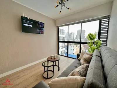 a living room with a couch and a large window at Fantastic 1BR at Barranco in Lima