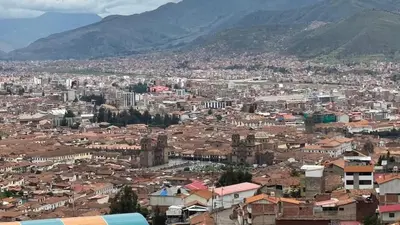 a view of a city with buildings and mountains at Santa Ana Home Cusco in Cusco