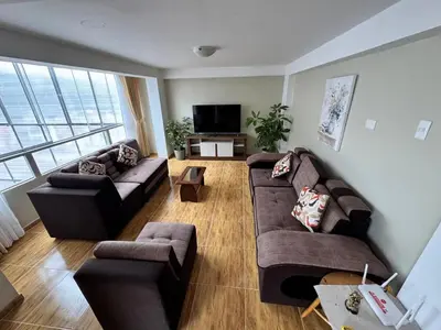 a living room with two couches and a television at Santa Ana Home Cusco in Cusco
