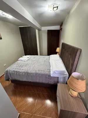 a small bedroom with a bed and a table at Santa Ana Home Cusco in Cusco