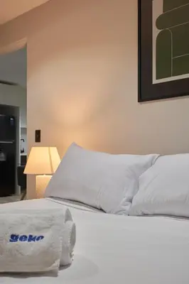 a bedroom with a bed with a towel on it at Geko | Contemporary 2BR w/Balcony near Costa Verde in Lima
