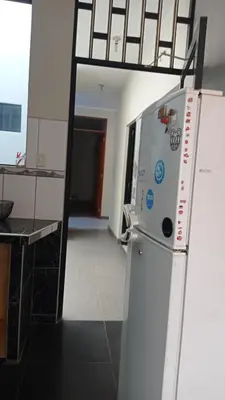a kitchen with a white refrigerator in a room at CHANCAY- 1er PISO DEPARTAMENTO in Chancay