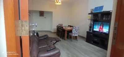 a living room with a couch and a table and a television at CHANCAY- 1er PISO DEPARTAMENTO in Chancay