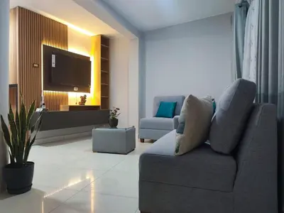 a living room with a couch and a tv at 3 bedroom apartment Ayacucho - Perú in Ayacucho