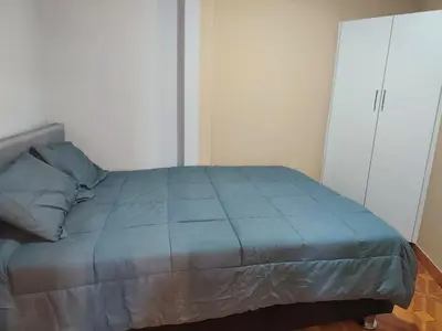 a bedroom with a bed and a white cabinet at 3 bedroom apartment Ayacucho - Perú in Ayacucho