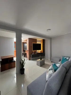 a living room with a couch and a television at 3 bedroom apartment Ayacucho - Perú in Ayacucho