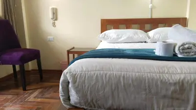 a bedroom with a bed with towels on it at San Blas B&B in Cusco