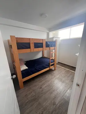 a small room with two bunk beds in it at Casa de playa con piscina 2 in Punta Negra