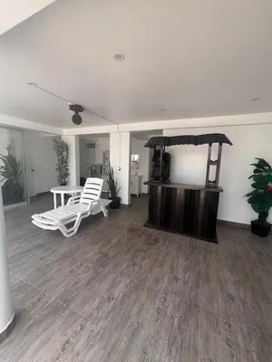 an empty living room with a table and chairs at Casa de playa con piscina 2 in Punta Negra