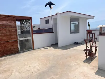 a patio with chairs and a door on a house at Casa de playa con piscina 2 in Punta Negra