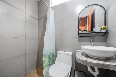 a bathroom with a white toilet and a sink at Equipped Loft with Sofa Bed and Balcony in Lima
