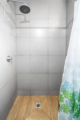 a shower with a shower curtain in a bathroom at Equipped Loft with Sofa Bed and Balcony in Lima
